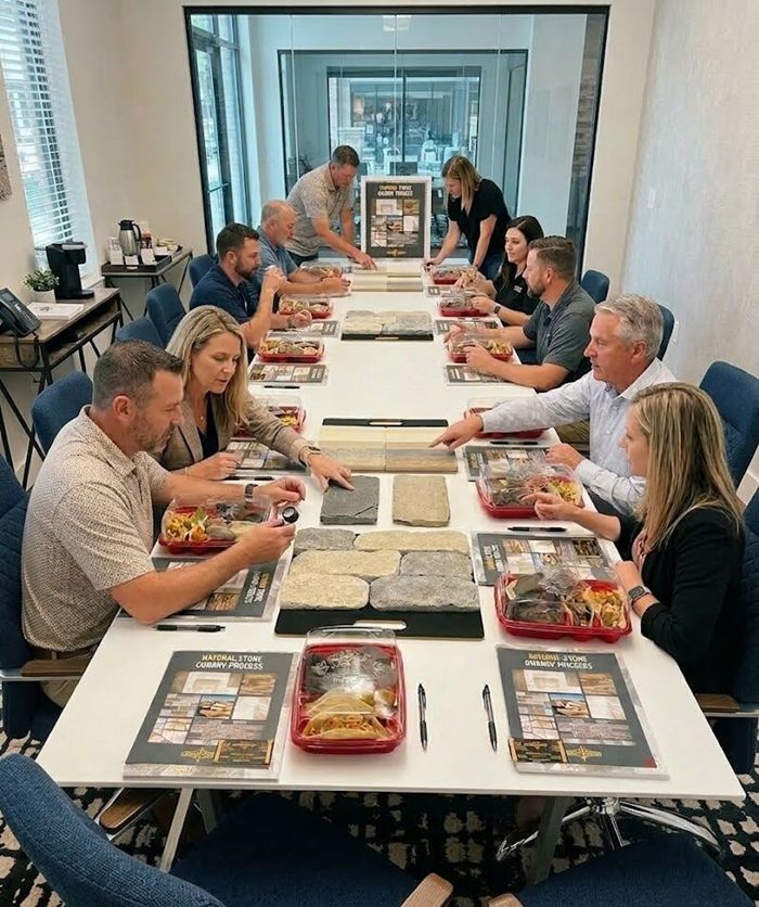 Taking notes at table Long table with people at it
