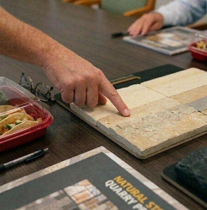 pointing at sample Finger pointing at stone sample